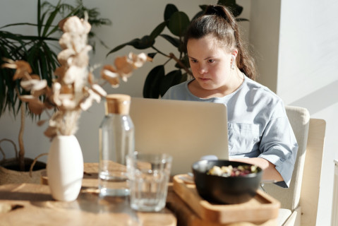 young-girl-using-laptop-over-breakfast.jpg