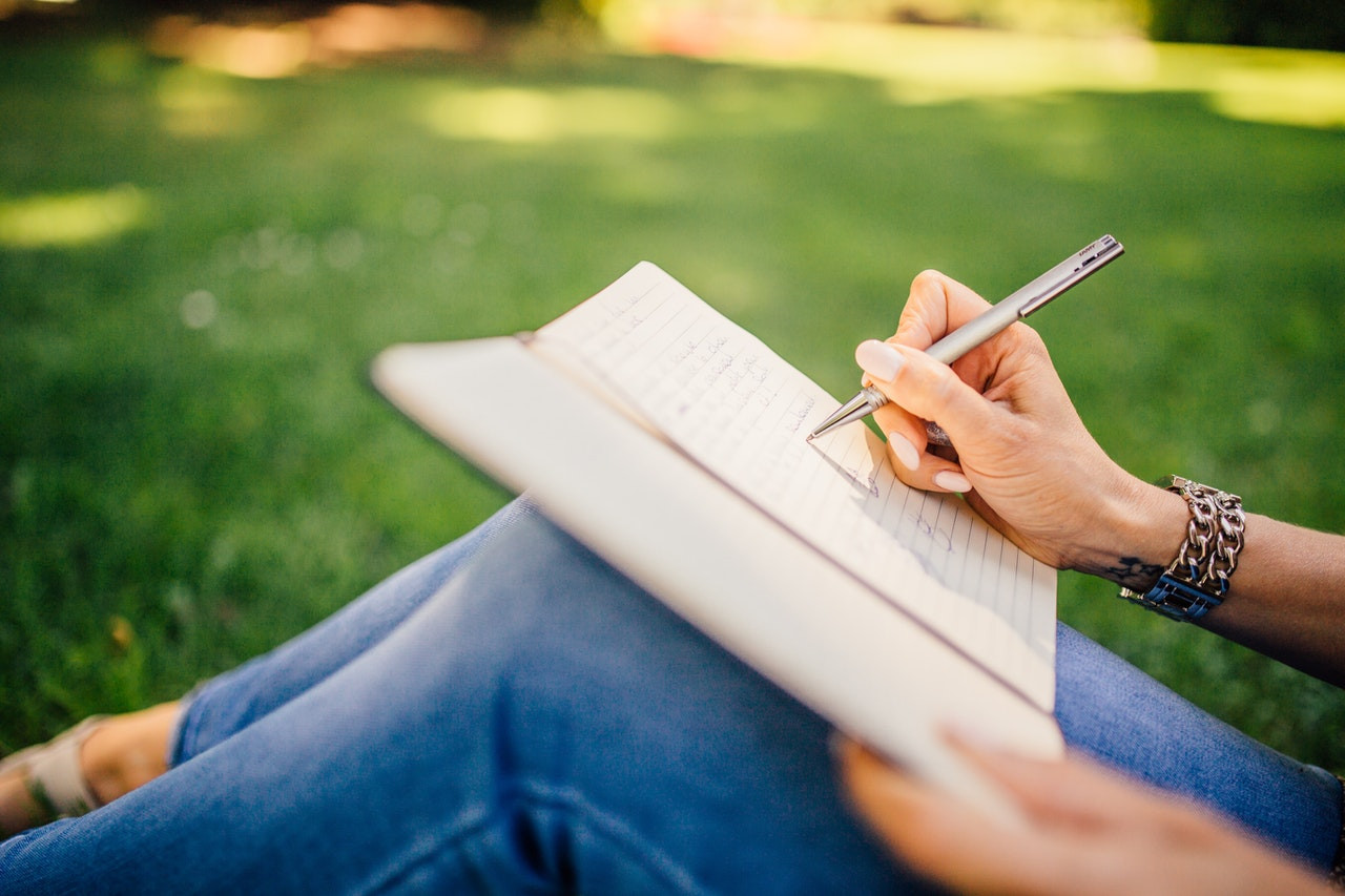 Journal Writing to Set Intentions while sitting in a park